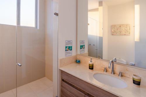 a bathroom with a sink and a shower at 41st Fl Beach Condo in Bocagrande in Cartagena de Indias