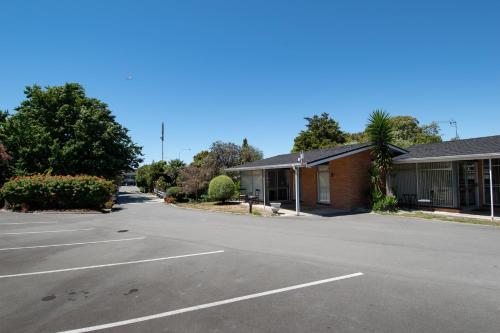 an empty parking lot in front of a building at Middle Park Motel in Blenheim