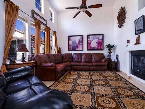 a living room with a leather couch and a fireplace at POOL SIDE, with free WiFi and GOLF PASS in La Ponderosa