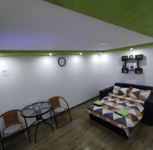 a bedroom with a bed and a table and chairs at NP Apartman Banja Jokin Grab -Bogatić 