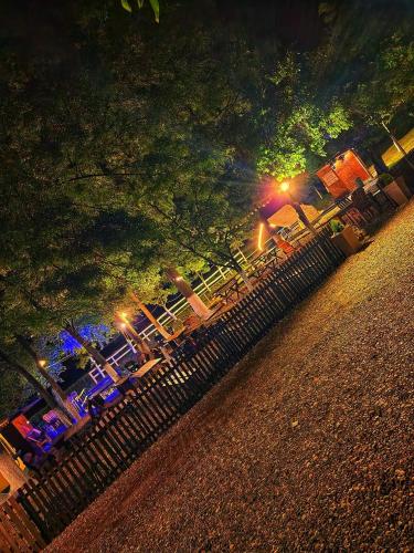 a group of tables and chairs in a park at night at NP Apartman Banja Jokin Grab -Bogatić 