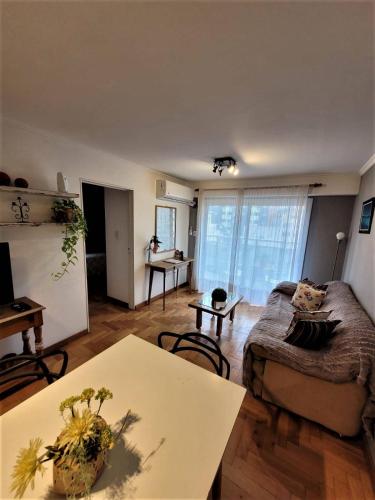 a living room with a couch and a table at Departamento Nueva Córdoba RW in Cordoba