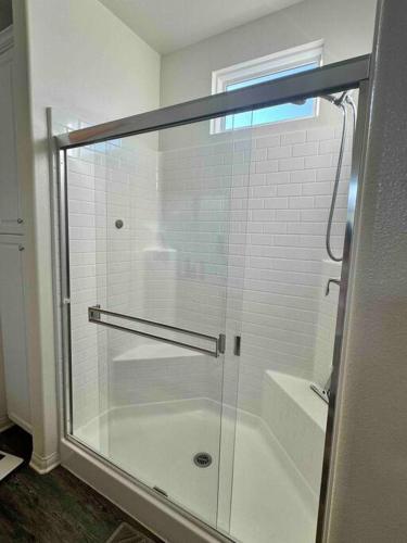 a shower with a glass door in a bathroom at Vacation or Business trip in Downey