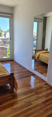 a room with two beds and a mirror at APARTAMENTOS FRERS in Martínez