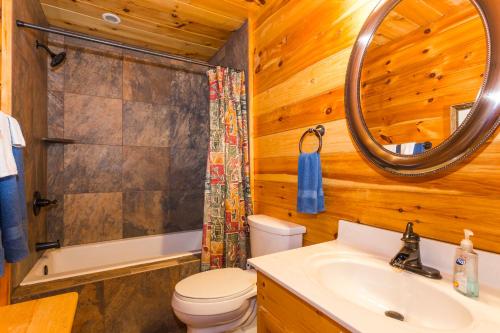 a bathroom with a toilet sink and a mirror at Dancing Bears Cabin Breathtaking Sunrise Mountain Views! in Old Fort