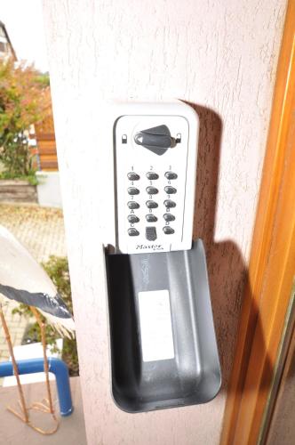 a cell phone is attached to a wall at Aux cigognes de Blotzheim in Blotzheim