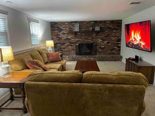 a living room with a couch and a fireplace at 2023 Remodeled 4bed/2bath Home! in Gansevoort