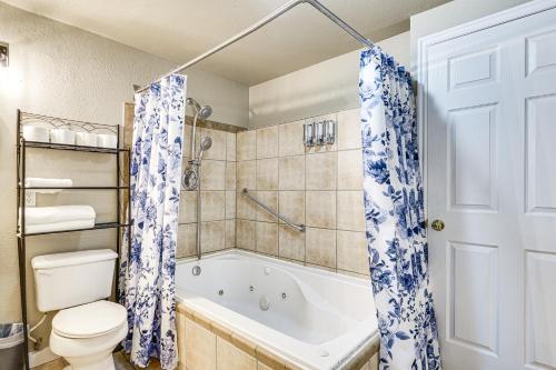 a bathroom with a white tub and a toilet and a shower at Pet-Friendly Utah Apartment 2 Mi to Amphitheatre in West Valley City