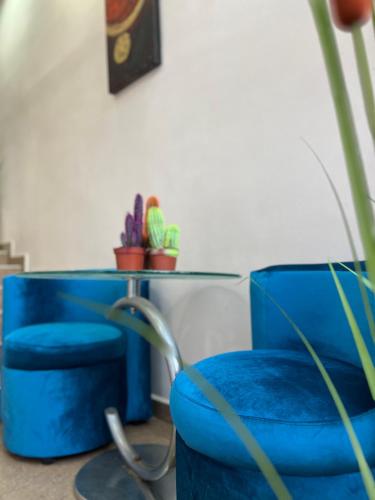 a blue chair sitting next to a table with plants at Hotel Han Krum in Targovishte