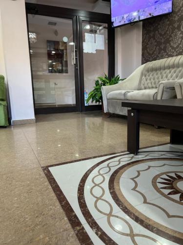 a living room with a couch and a tv at Hotel Han Krum in Targovishte