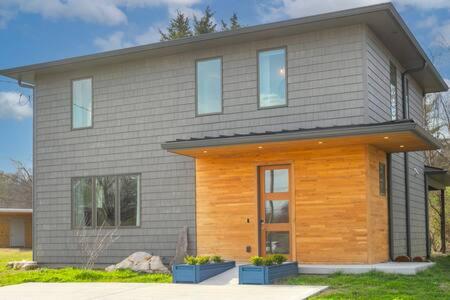 a gray house with a brown and wooden at ADA Accessible Dog Friendly Home with Patio, Yard Ample Parking, Great for Families, 12 Mins to Broadway, 12South, Geodis Park, 24 Hr Hospitality in Nashville