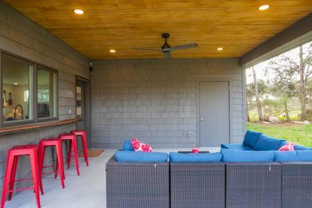a patio with red and blue chairs and a bar at ADA Accessible Dog Friendly Home with Patio, Yard Ample Parking, Great for Families, 12 Mins to Broadway, 12South, Geodis Park, 24 Hr Hospitality in Nashville