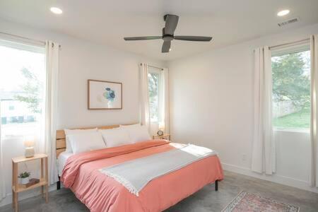 a bedroom with a bed and a ceiling fan at ADA Accessible Dog Friendly Home with Patio, Yard Ample Parking, Great for Families, 12 Mins to Broadway, 12South, Geodis Park, 24 Hr Hospitality in Nashville