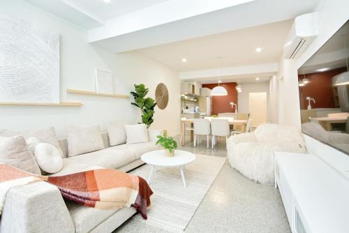 a living room with a couch and a table at Loft Deluxe & Fun - Downtown Quebec in Quebec City
