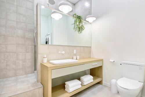 a bathroom with a sink and a toilet at Loft Deluxe & Fun - Downtown Quebec in Quebec City