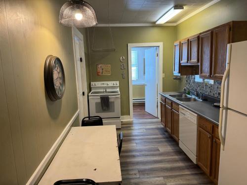 a kitchen with a table and a counter top at Fenway House Hotel in Fennimore