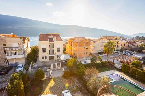 an aerial view of a town with a pool at Sunny Portside Apartment in Ðenovići