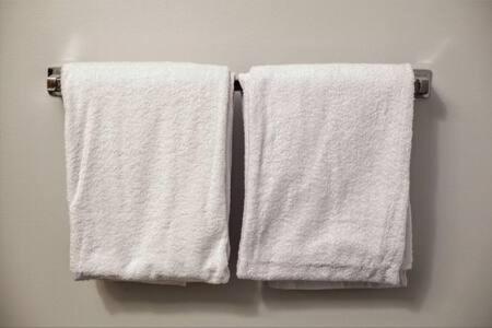 two towels hanging on a towel rack in a bathroom at TWO Bold 2BR 2BA Apartments by CozySuites in Indianapolis
