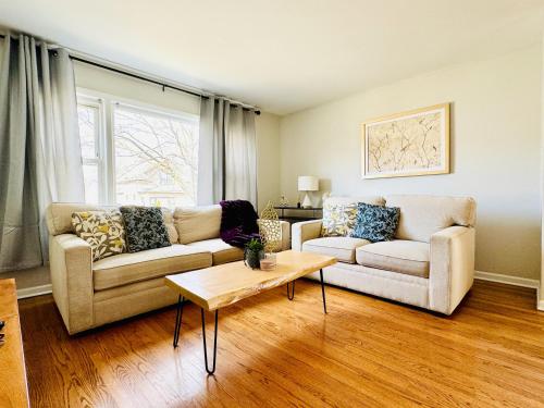 a living room with two couches and a coffee table at Charming and Convenient 3br 1ba apt - fully furnished and equipped - fast Internet in Forest Park