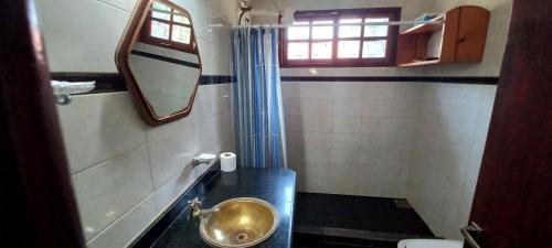 a bathroom with a sink and a mirror at Posada de Ana in Puerto Iguazú