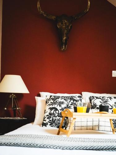 a bedroom with a bed with a skull on the wall at L'Insolite, Suite safari d'exception à Saumur in Saumur