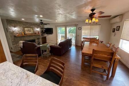a living room with a table and a dining room at Creekside Dream Game Room Sleeps 12 bbq near town in Oakhurst