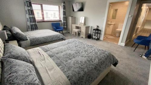 a bedroom with three beds and a room with at Johnny Murphy's Guest Rooms in Meigh
