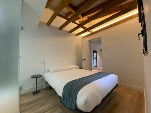 a bedroom with a large white bed and wooden floors at Fomento by Wynwood House in Madrid