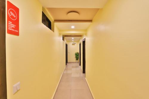 a hallway in a hospital with a sign on the wall at Hotel Green Land in Ahmedabad