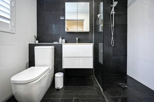 a bathroom with a toilet and a sink and a shower at Golden Beach Family Relaxation in Golden Beach