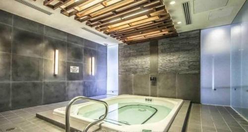a large bathroom with a bath tub in a room at 300 Front Suites - Two Beds with Free Parking in Toronto