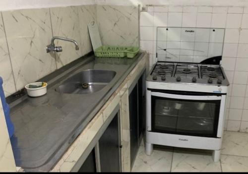 a small kitchen with a stove and a sink at Hostel Brasil Recife in Recife