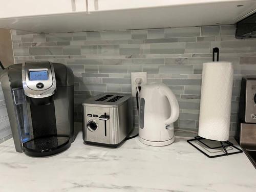 a kitchen counter with a coffee maker and a toaster at Adorable new studio with free parking and WiFi in Federal Way