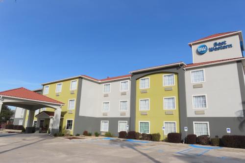 a hotel with a yellow and white building at Best Western Heritage Inn & Suites in Broussard