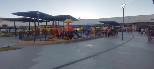a playground in front of a building with people at CASA VIOLETAS a 20 minutos de aeropuerto AIFA in Mexico City