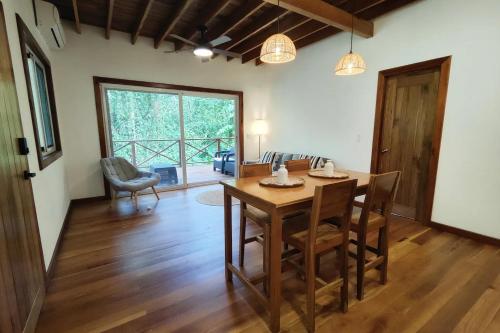 a dining room with a wooden table and chairs at Gaia Nature Lodges at Bluff Beach in Bocas del Toro