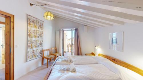a bedroom with a large white bed in a room at Polaschin A8 in Sils Maria