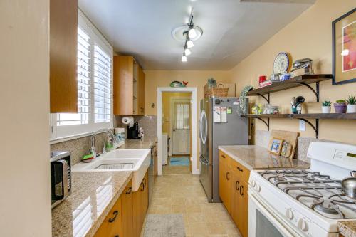 a kitchen with a sink and a refrigerator at Charming Bungalow Near LA Waterfront and Beaches in San Pedro