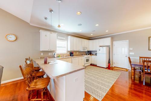 a kitchen with white cabinets and a table and chairs at The Tigers Oasis in Seneca