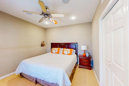a bedroom with a bed and a ceiling fan at The Tigers Oasis in Seneca