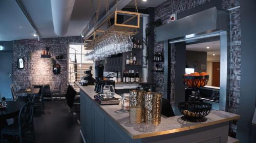 a bar in a restaurant with a brick wall at Hotell Boras, BW Signature Collection in Borås