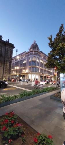 a large building on a city street with cars at CASA VIOLETAS a 20 minutos de aeropuerto AIFA in Mexico City