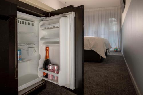 an open refrigerator with a bottle of beer in it at LyLo Brisbane in Brisbane