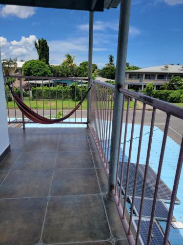 a hammock on a balcony overlooking the water at Chinese family kingdom in Nadi