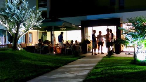 a group of people standing outside of a restaurant at Hotel Raffl in Bolzano