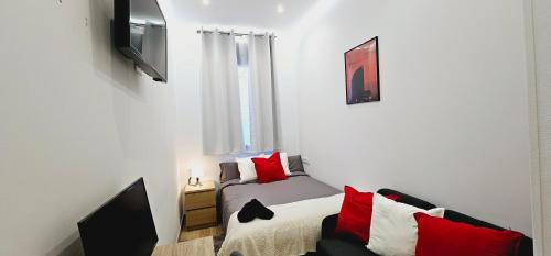 a small room with a bed and a tv at Gran apartamento ideal grupos muy cerca Barcelona in Badalona