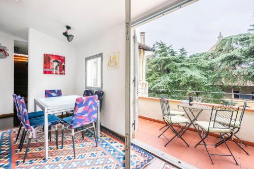 a dining room with a table and chairs on a balcony at Penthouse Le Terrazze Duomo view in Florence