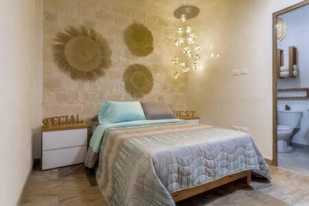 a bedroom with a bed and a sink and a toilet at Cipressi Spectacular Italian Tuscan style loft in Santeagueda
