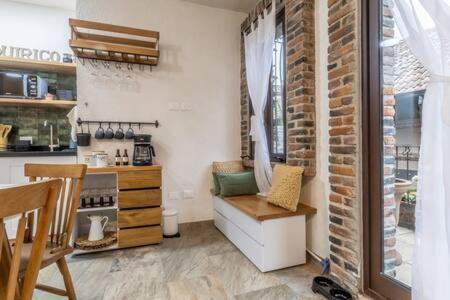a kitchen with a counter and a stove top oven at Cipressi Spectacular Italian Tuscan style loft in Santeagueda