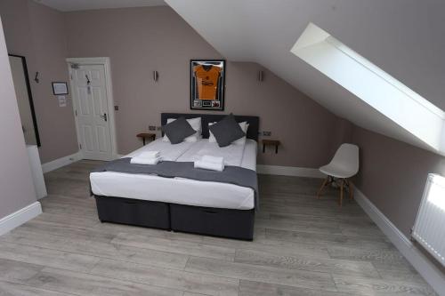 a bedroom with a large bed in a attic at Hotel Tia in Liverpool